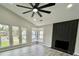 Bright living room featuring a vaulted ceiling, fireplace, and large windows offering ample natural light at 295 Lamden Ct, Lawrenceville, GA 30046