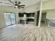 Open concept living room flows into kitchen with hardwood style flooring at 295 Lamden Ct, Lawrenceville, GA 30046
