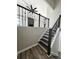 Elegant staircase featuring wrought iron spindles, hardwood steps, and a view of the living area at 295 Lamden Ct, Lawrenceville, GA 30046