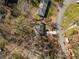 Aerial view of the house with a long paved driveway; there are mature trees on the landscaped property at 750 Parkway Se Dr, Smyrna, GA 30080
