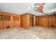 Unfinished basement featuring paneling and a decorative tornado ceiling mural at 750 Parkway Se Dr, Smyrna, GA 30080