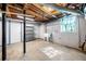 Unfinished basement with concrete floor, exposed ceiling, storage, and utility sink at 750 Parkway Se Dr, Smyrna, GA 30080