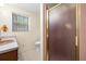 Bathroom featuring a pink sink, shower and white tile flooring at 750 Parkway Se Dr, Smyrna, GA 30080