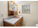 Bathroom featuring a pink sink, wooden cabinets and white tile flooring at 750 Parkway Se Dr, Smyrna, GA 30080