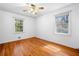 Bright bedroom featuring hardwood floors, natural lighting from two windows, and neutral walls at 750 Parkway Se Dr, Smyrna, GA 30080