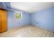 Small bedroom with light blue walls and basic flooring at 750 Parkway Se Dr, Smyrna, GA 30080