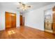 Bedroom featuring hardwood floors, a ceiling fan with lighting, and access to an attached bathroom at 750 Parkway Se Dr, Smyrna, GA 30080