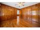 Bedroom featuring wood paneling, hardwood floors and a ceiling fan at 750 Parkway Se Dr, Smyrna, GA 30080