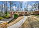 Charming brick home featuring manicured front lawn, inviting walkway, and classic architectural details at 750 Parkway Se Dr, Smyrna, GA 30080