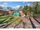 Back exterior of brick home with a green metal storage shed on a grassy lawn at 750 Parkway Se Dr, Smyrna, GA 30080