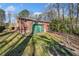 Back view of the brick house with a deck, green shed and large backyard at 750 Parkway Se Dr, Smyrna, GA 30080