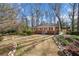Traditional brick home features a well-kept lawn and a stone-lined garden bed at 750 Parkway Se Dr, Smyrna, GA 30080