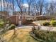 Brick home with well-maintained lawn, landscaped with greenery, hardscape and flowering bushes at 750 Parkway Se Dr, Smyrna, GA 30080