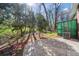 Concrete patio and trees in full bloom next to a brick house with a green shed at 750 Parkway Se Dr, Smyrna, GA 30080