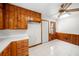 Traditional kitchen featuring wood cabinets, white countertops, tile flooring, and natural lighting from the nearby window at 750 Parkway Se Dr, Smyrna, GA 30080