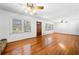 Spacious living room with hardwood floors, stone fireplace, and ample natural light from large windows at 750 Parkway Se Dr, Smyrna, GA 30080