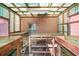 Interior of the green shed with brick walls, shelving and light fixture at 750 Parkway Se Dr, Smyrna, GA 30080