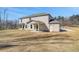 Large backyard showcasing the home's rear exterior, including a covered patio and brick facade at 209 Haverling Pass, Hampton, GA 30228