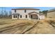 Home exterior featuring a spacious backyard with a covered patio, perfect for outdoor enjoyment at 209 Haverling Pass, Hampton, GA 30228