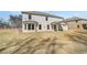 Back exterior of a two-story house with an expansive yard and covered patio, beautiful view at 209 Haverling Pass, Hampton, GA 30228