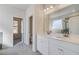 Bathroom features double sinks with white cabinets and a large mirror at 209 Haverling Pass, Hampton, GA 30228