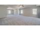 Expansive bedroom with plush carpeting, neutral walls, and a tray ceiling with fan and recessed lighting at 209 Haverling Pass, Hampton, GA 30228
