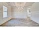 Elegant dining room featuring gray wood flooring, a chandelier, and decorative wall trim at 209 Haverling Pass, Hampton, GA 30228