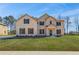 Charming two-story brick home featuring a manicured lawn and inviting front entrance at 209 Haverling Pass, Hampton, GA 30228