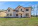 Charming two-story brick home featuring a manicured lawn and inviting front entrance at 209 Haverling Pass, Hampton, GA 30228