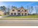 Charming two-story brick home featuring a manicured lawn and inviting front entrance at 209 Haverling Pass, Hampton, GA 30228