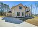 Attractive home featuring an attached three-car garage and long concrete driveway at 209 Haverling Pass, Hampton, GA 30228