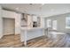 Eat-in kitchen features white cabinetry, stainless appliances, an island and access to the backyard at 209 Haverling Pass, Hampton, GA 30228