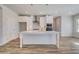 Well-lit kitchen boasts white cabinets, stainless steel appliances, and a large island at 209 Haverling Pass, Hampton, GA 30228