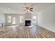 Bright living room featuring a fireplace, ceiling fan, and access to the outdoor patio at 209 Haverling Pass, Hampton, GA 30228