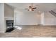 Living room has a fireplace, staircase, and modern flooring at 209 Haverling Pass, Hampton, GA 30228