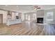 Spacious open-concept kitchen and living room with fireplace and large windows at 209 Haverling Pass, Hampton, GA 30228