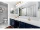 Well-lit bathroom featuring a large mirror, white countertop, blue cabinets, and a toilet at 64 Montre Nw Sq, Atlanta, GA 30327