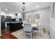 Bright dining area with a modern table set and a view into the updated kitchen with stainless steel appliances at 64 Montre Nw Sq, Atlanta, GA 30327