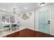 Charming dining area with a round table, stylish chairs, natural light, and a decorative teal door at 64 Montre Nw Sq, Atlanta, GA 30327