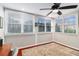 Cozy sunroom with hardwood floors, multiple windows, and a ceiling fan, offering ample natural light at 64 Montre Nw Sq, Atlanta, GA 30327