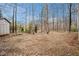 Large backyard with a shed. Property is surrounded by tall trees and sparse green growth at 79 Mountain View Ct, Dallas, GA 30157