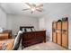 Cozy bedroom featuring a ceiling fan, a dark wooden bed frame, carpeted floor, and a bookshelf with books at 79 Mountain View Ct, Dallas, GA 30157
