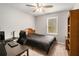 This bedroom has a cozy feel with ceiling fan, desk, and a window at 79 Mountain View Ct, Dallas, GA 30157