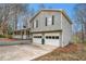 Side view of a two-story home with gray siding, a two-car garage, and a covered porch at 79 Mountain View Ct, Dallas, GA 30157