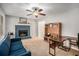 Bright living room with a stone fireplace, ceiling fan, and ample seating at 79 Mountain View Ct, Dallas, GA 30157