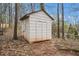 Wooden shed on a grassy lot. The shed has double doors, an angled roof and wood paneling at 79 Mountain View Ct, Dallas, GA 30157