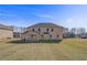 Expansive backyard featuring a well-maintained lawn and the rear facade of the home at 200 Haverling Pass, Hampton, GA 30228