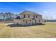 Large backyard with a freshly sodded lawn and view of the home's rear exterior at 200 Haverling Pass, Hampton, GA 30228