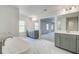 Bright bathroom with a soaking tub, double vanities and stylish marble tile at 200 Haverling Pass, Hampton, GA 30228