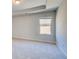 Bedroom featuring one window, neutral colored carpet, and trey ceiling at 200 Haverling Pass, Hampton, GA 30228